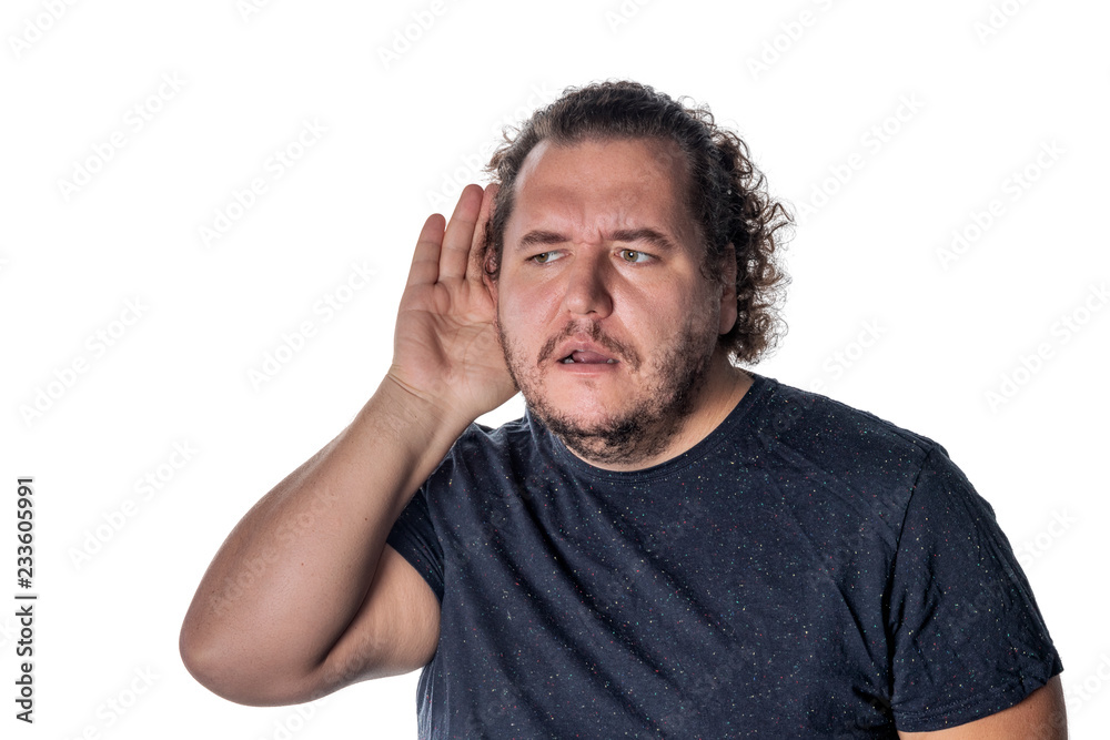 Fat man, trying to hear someone putting his hand on his ear, standing on a white background Fat man, trying to hear someone putting his hand on his ear, standing on a white background