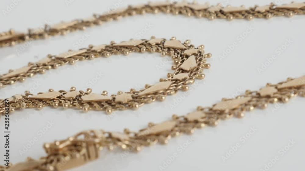 Panning over detailed golden necklace chain 4K video