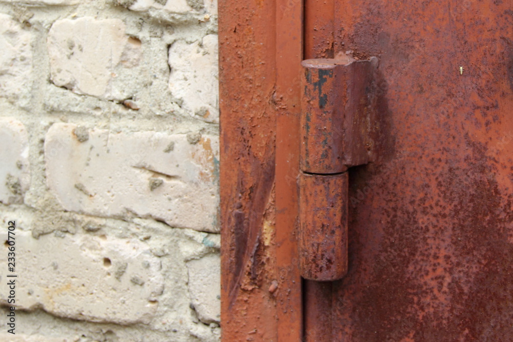 Old rusty iron hinge on garage door close-up - security, theft protection Old rusty iron hinge on garage door close-up - security, theft protection