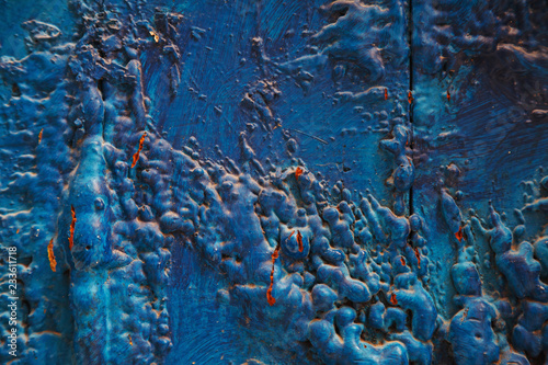 Bright turquoise blue painted textured surface made of construction foam on wood