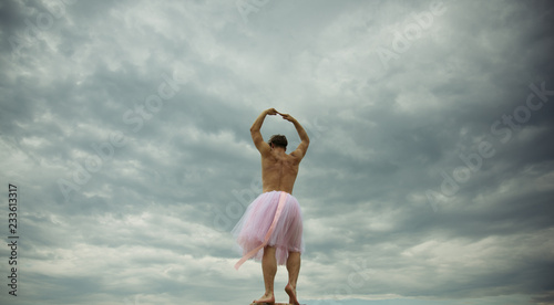 Man dancing in tutu at ballet studio. Funny man freak. Man in ballerina skirt outdoor. Inspiration dreaming. Crazy ballerina. drag queen. Enjoying his favorite music. fun in motion. dancing in sky