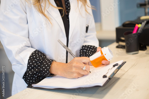 Pharmacist filling prescription in pharmacy