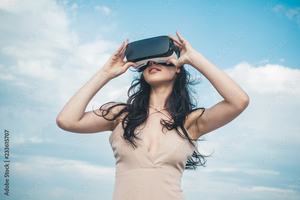 Girl using VR headset. Woman getting experience using VR-headset glasses. Visual reality concept. Digital future and innovation. Woman with glasses of virtual reality. Cool. Enjoying new experience