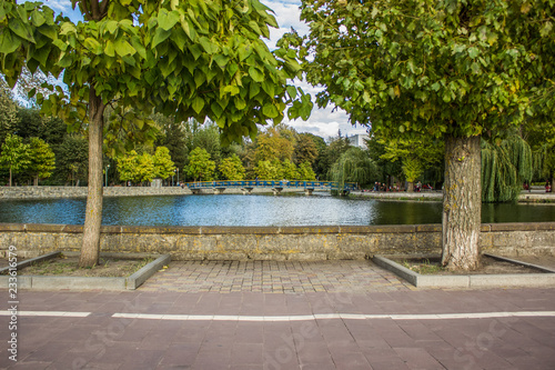 Wallpaper Mural symmetry park outdoor view between trees to lake water surface and small bridge, good landscape design for rest and walking, Ternopil, Ukraine   Torontodigital.ca