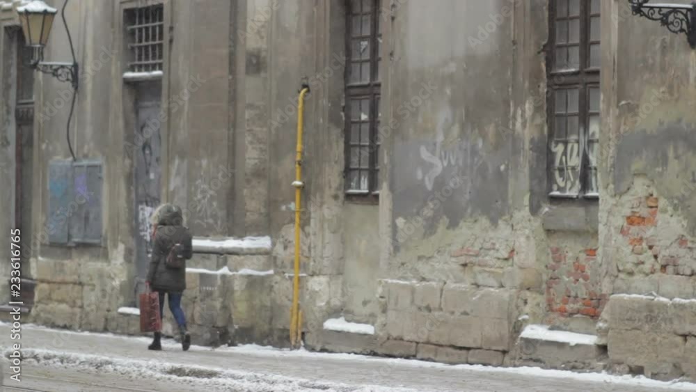 The girl goes by the old streets in winter,A young student goes along the street in winter The girl goes by the old streets in winter,A young student goes along the street in winter