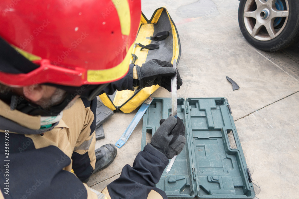 Fototapeta premium Firemen practicing techniques of rescue of victims in traffic accidents with tools