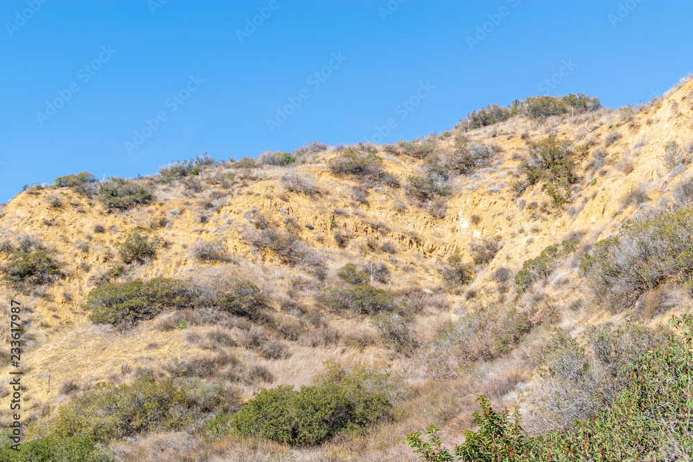 Rugged foothills of California mountains on warm fall day with room for text in sky