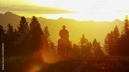 Silhouette of Cowboy Riders forest wilderness area Canada