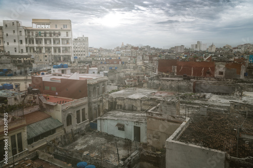 Panoramic view over the rooftops of Havana City in Cuba. The run-down buildings mostly in colonial style provide a special flair for visitors and tourists. Sun stream and lens flare included.