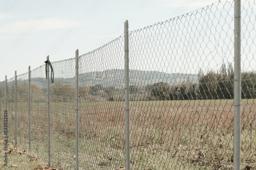 Metallic fence in the field (Pesaro, Italy, Europe)