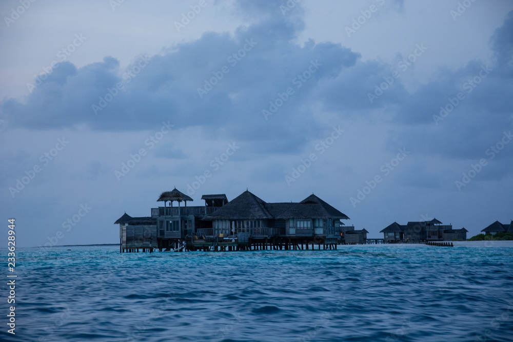 amazing bungalows in the middle of the sea in the Maldives at sunrise