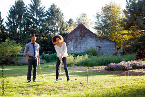 Valokuva Couple enjoying croquet game on grassy field