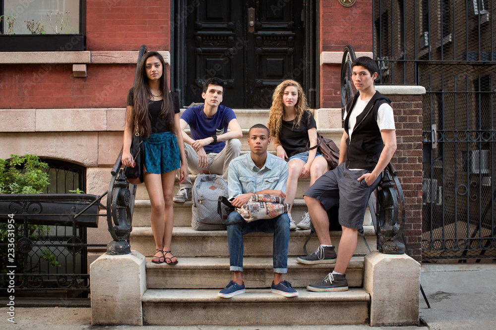 Fototapeta premium Portrait of friends on steps against building