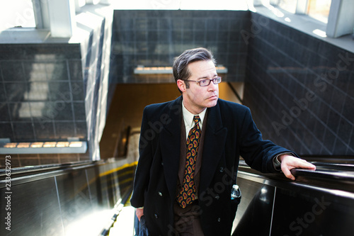 High angle view of man looking away while standing on escalator
