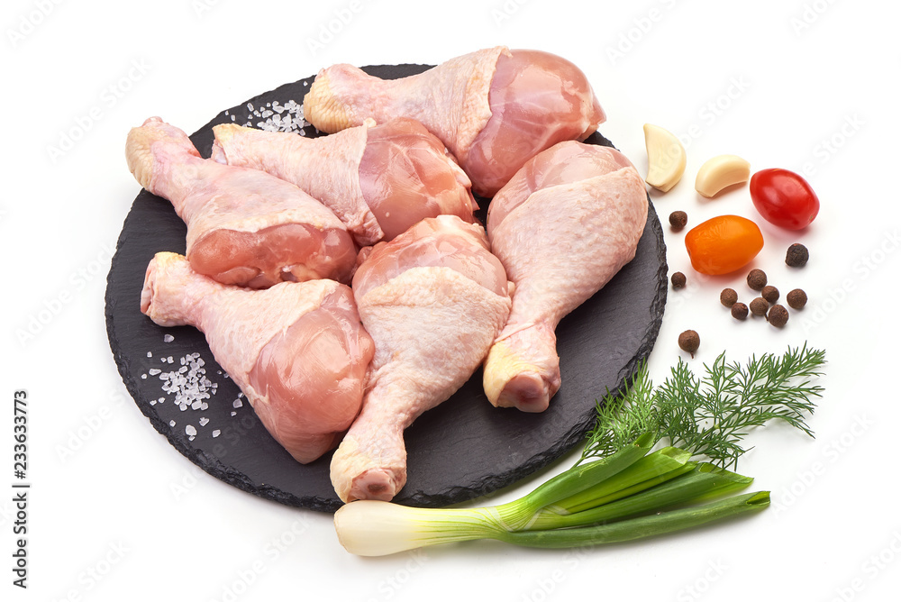 Raw Chicken Legs (drumsticks) with spices, isolated on a white background. Close-up. Raw Chicken Legs (drumsticks) with spices, isolated on a white background. Close-up.