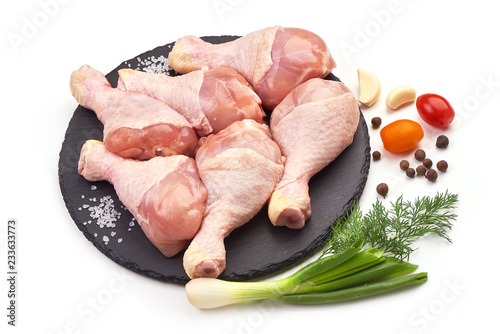 Raw Chicken Legs (drumsticks) with spices, isolated on a white background. Close-up.