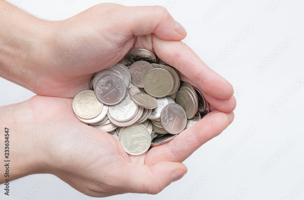 Female hands holding Russian iron coins close up isolator on a white background. a bunch of Russian coins. Russia crisis. small currency. little things Female hands holding Russian iron coins close up isolator on a white background. a bunch of Russian coins. Russia crisis. small currency. little things