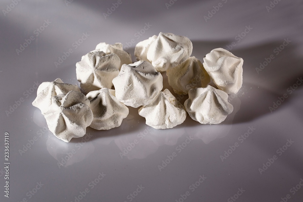 Close up view of beautiful white meringue cookies. Traditional dessert of French/ Swiss /Italian cuisine.