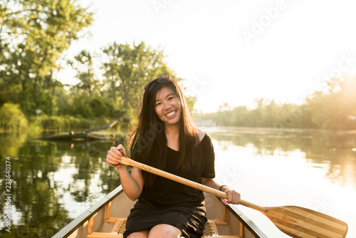 Woman canoeing at sunset