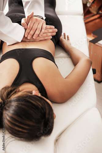 Obraz na plátně High angle view of osteopath examining woman at clinic