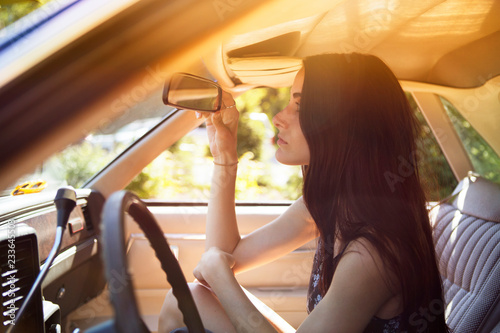 Canvas-taulu Side view of woman looking in rear-view mirror in pick-up truck