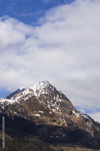 Snow on Hintereggkogel and Ochsenbug Mountain peaks in ski resort Matrei in Osttirol, Austria, sunny day © josefkubes