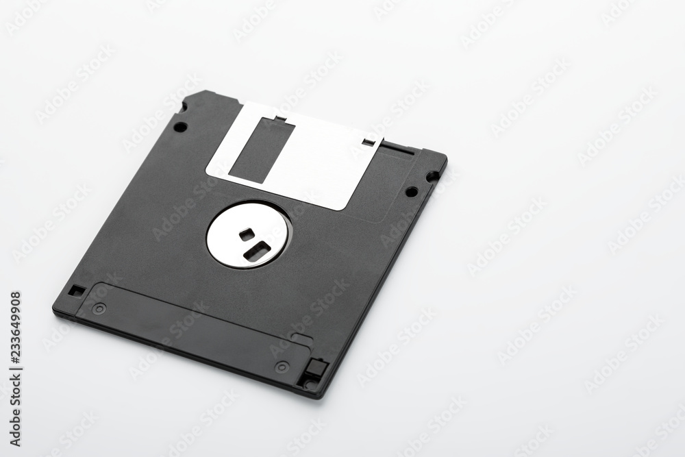 Old computer diskette over white background. Black Diskette. Old computer diskette over white background. Black Diskette.