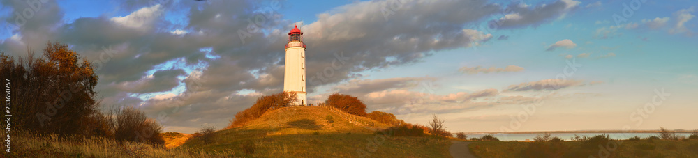 Autumn panoramic image of Hiddensee island on Baltic sea with white lighthouse Dornbusch
