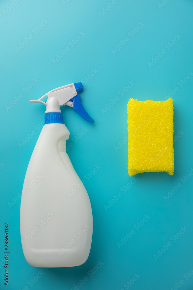 cleaning agent in a white bottle with a sponge on a blue background