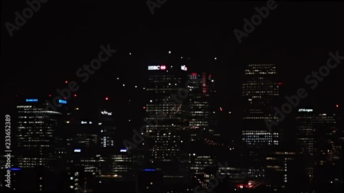 UK November 2018 - Slow motion of a barrage of fireworks exploding in front of Canary Wharf financial district in London at night. photo