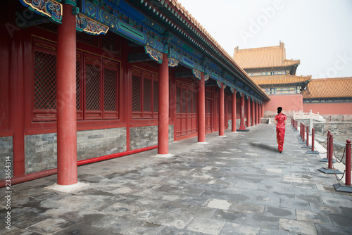 Asian young woman in old traditional Chinese dresses in the Forbidden city in Beijing, China.