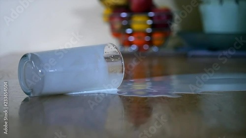 Glass of milk spills in slow motion