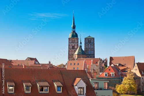 Orange tiled roofs of Stralsund with towers of medieval parish Church of St. Nicholas