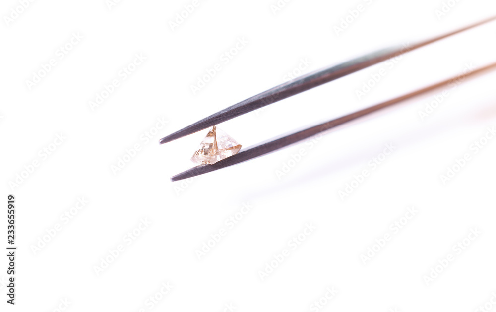 natural transparent diamond in the form of a pyramid in tweezers natural transparent diamond in the form of a pyramid in tweezers