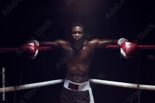 Obraz na płótnie Portrait of boxer leaning while standing in boxing ring