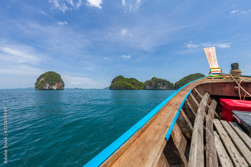 Wooden Boat rides on the turquoise sea