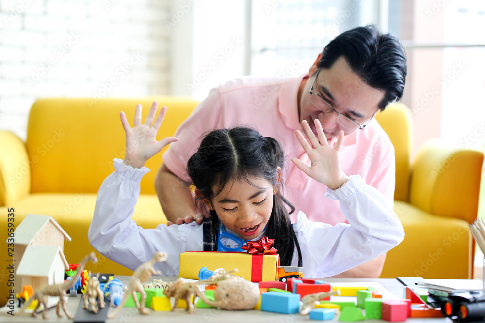 Parent and little child having fun playing educational toys,Family concept.