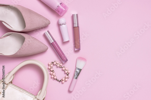Layflat image of pink womans fashion and cosmetics products.