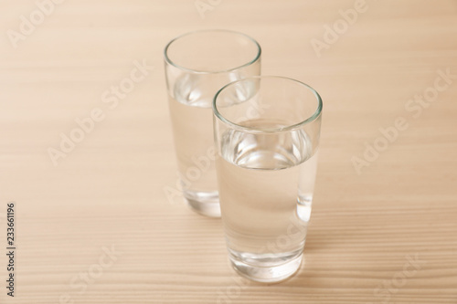 Glasses of fresh water on wooden table