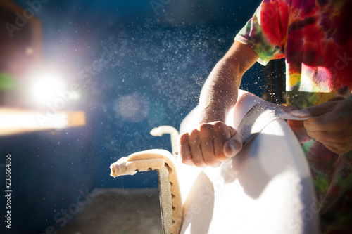 Fotografija Cropped image of man shaping surfboard in workshop