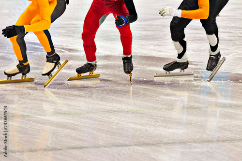 Obraz na plátně Low section of skaters in skating ring