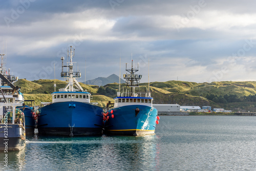 фотографія A Front Bow View of Alaskan Fishing Crab Boats at Port in Dutch Harbor Alaska