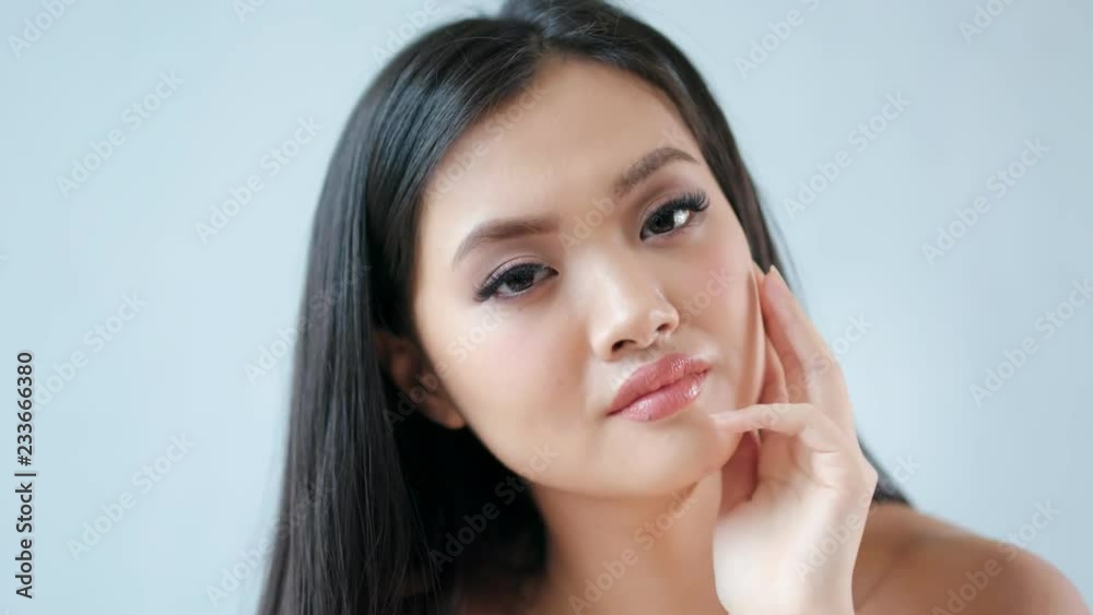 Isolated close-up portrait pretty Asian young woman having beautiful black hair and natural makeup Isolated close-up portrait pretty Asian young woman having beautiful black hair and natural makeup