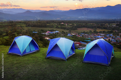 Outdoor camping tent among meadow on mountain during sunset at Yun Lai Viewpoint, Pai town , Mae Hong Son in Thailand. This is very popular for photographers and tourists.Travel and natural Concept