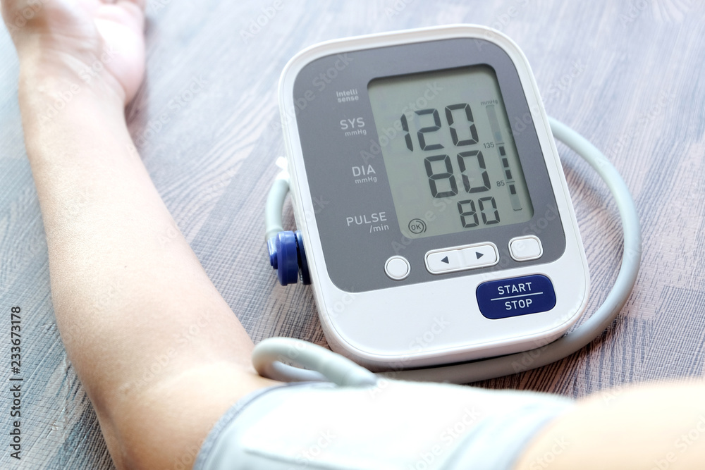Human check blood pressure monitor and heart rate monitor with digital pressure gauge. Health care and Medical concept Human check blood pressure monitor and heart rate monitor with digital pressure gauge. Health care and Medical concept