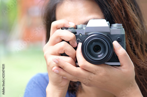 hipster lifestyle of cute girl She holds a camera. And save photos On a digital camera.Travel and Lifestyle concept