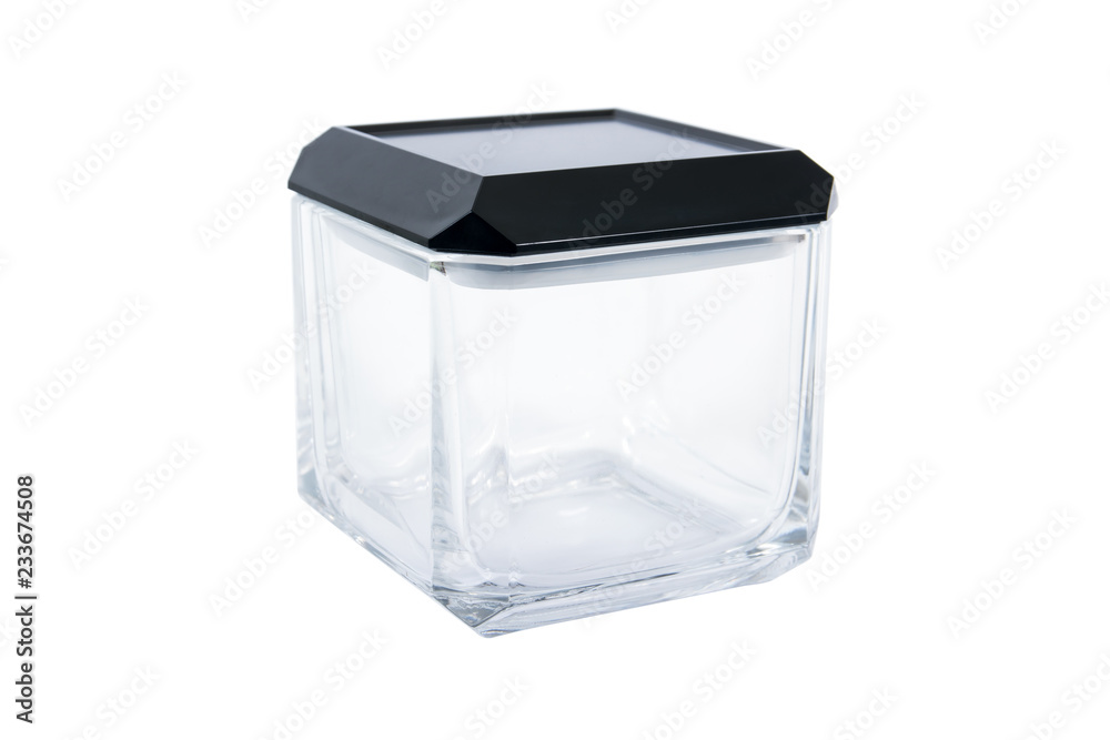Square glass box container with cover isolated on white background. Square glass bottle with black cap isolated
