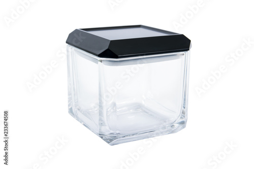 Square glass box container with cover isolated on white background. Square glass bottle with black cap isolated