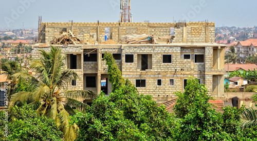 Construction site. Nice photo of unfinished building on a town background. Contemporary urban landscape. Developing of modern civil engineering. Construction industry