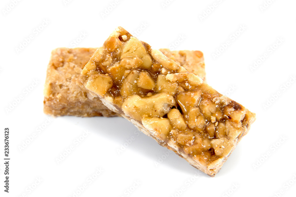 It is two closeup of caramel peanuts bar isolated on white background.Honey brittle peanuts isolated It is two closeup of caramel peanuts bar isolated on white background.Honey brittle peanuts isolated